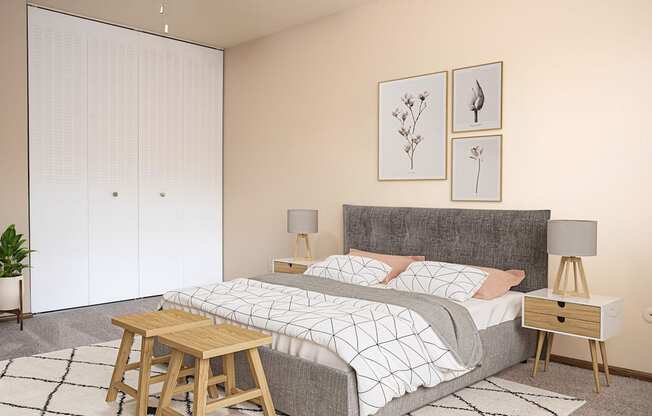 A bedroom with a bed, nightstands, and a plant.