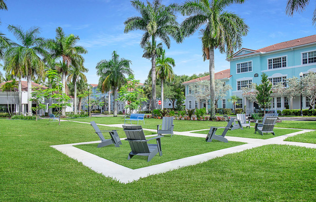 A park with benches and palm trees at Floresta apartments in Jupiter, FL