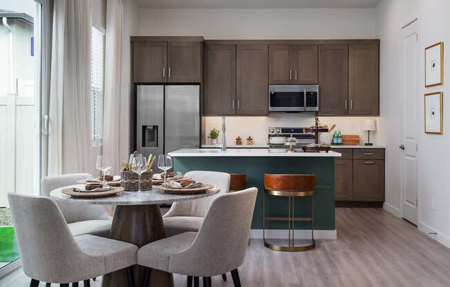 A kitchen with a table set for four.