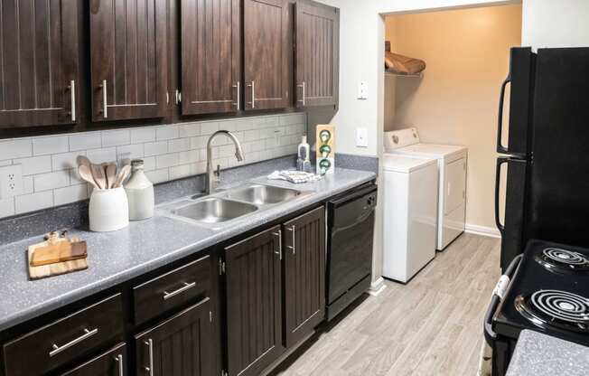 Kitchen with in unit laundry located at Addison on Cobblestone located in Fayetteville, GA 30215