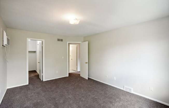 Spacious bedroom with natural light, walk-in closets, carpeting. Cozy one bedroom apartments in Southfield, MI.