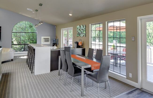 Resident clubhouse with long community table and hightop bar seating at 2000 Lake Washington Apartments, Renton, 98056