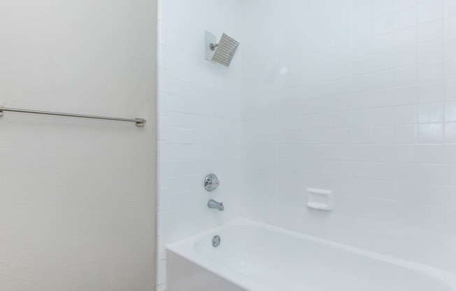 a bathroom with a tub and shower