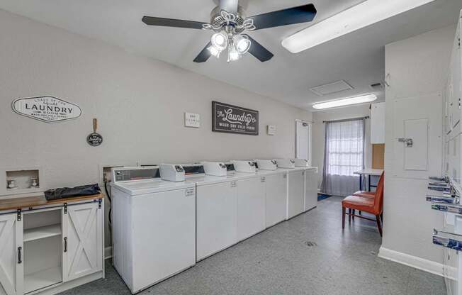 A laundry sign is on the wall above a washer and dryer.