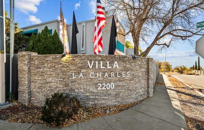 the sign for the villa la chrysalis building with an flag