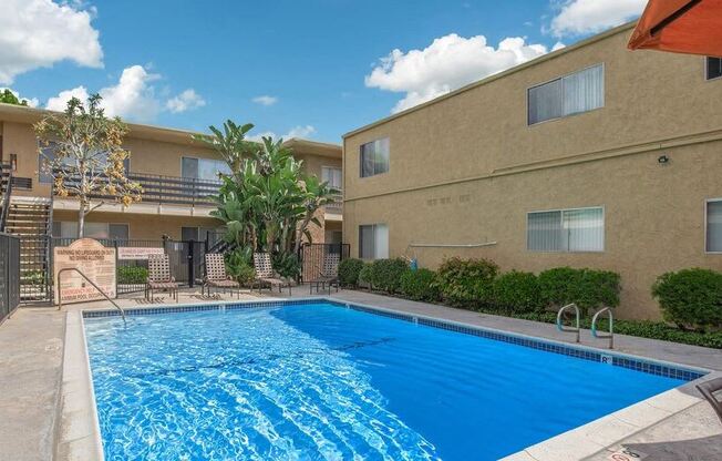 a large swimming pool in front of a building at Villa La Paz Apartments, California, 90706