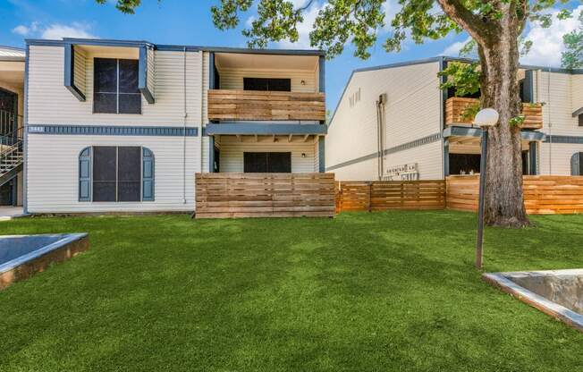 a backyard with a tree and a swimming pool