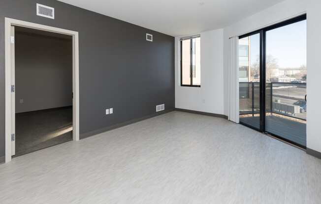 Modern open-concept kitchen and living area with stainless steel appliances.