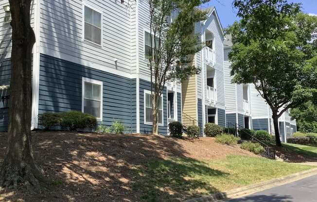 our apartments are located on the corner of a street with trees