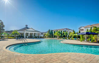 a swimming pool with houses in the background