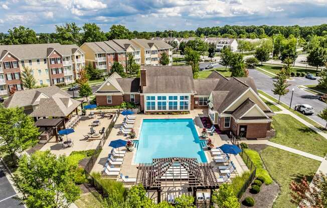 an aerial view of the resort style pool with lounge chairs around it