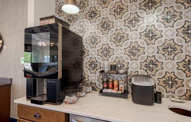 A coffee maker and a toaster are on a countertop.