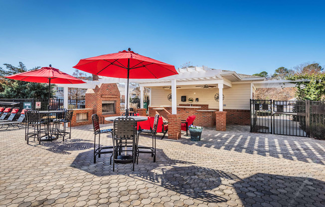 a patio with tables and chairs and umbrellas