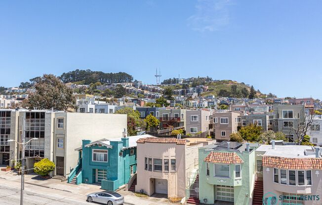 Sunset: Large Top Floor Studio Apartment with Onsite Laundry, Optional Parking, & City Views