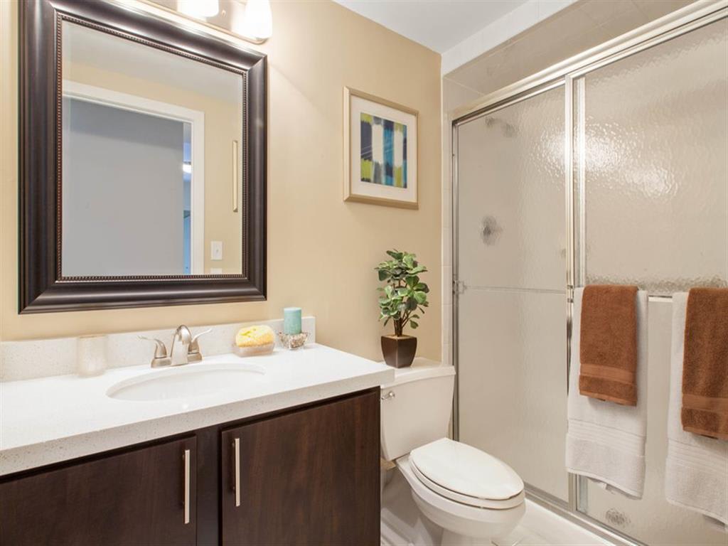 Modern bathroom with tub and hammered glass shower door, at Prospect Place NJ