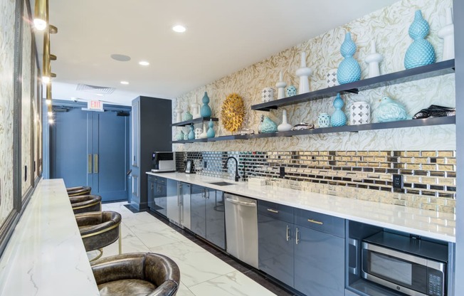 a large kitchen with blue cabinets and counter tops and a sink