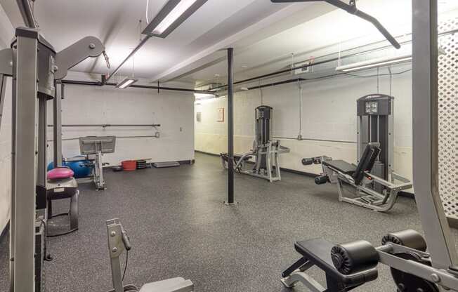 a gym with weights and other equipment in a building