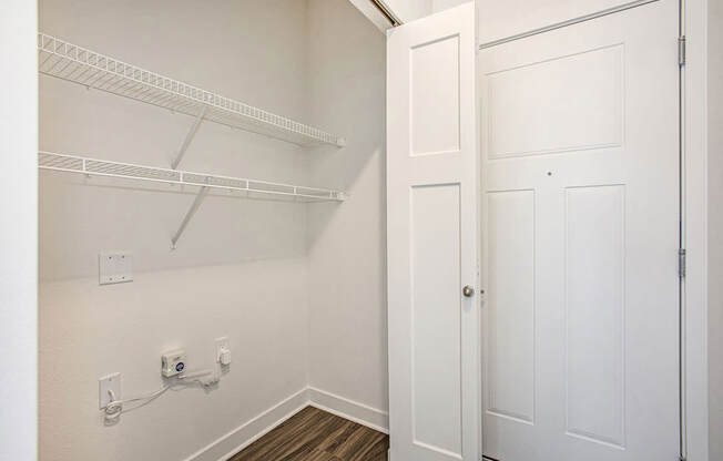 An entry closet with shelves at Meadowbrooke Apartment Homes in Kentwood, MI 49512