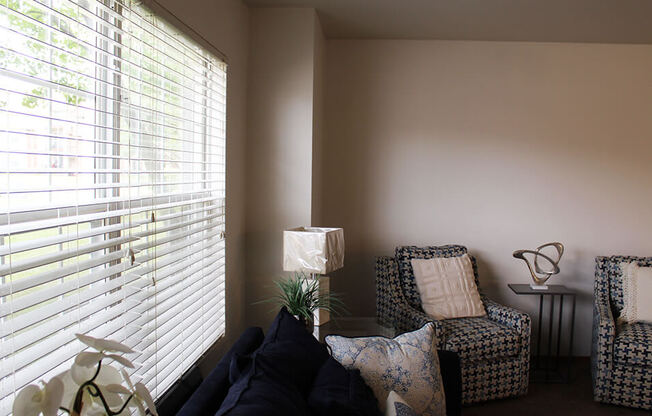 a living room with two chairs and a couch