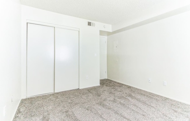 a bedroom with a carpeted floor and white walls