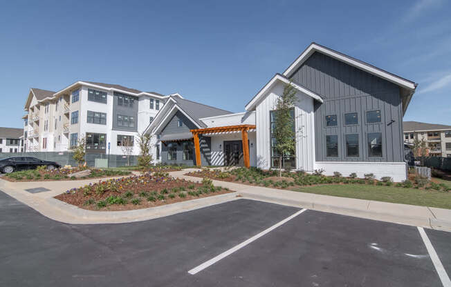 an exterior view of a building with a parking lot