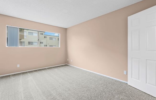 a bedroom with pink walls and a white door