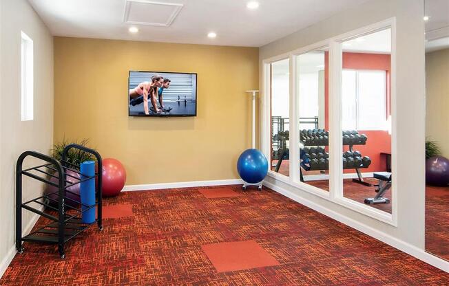 a gym with a tv on the wall
