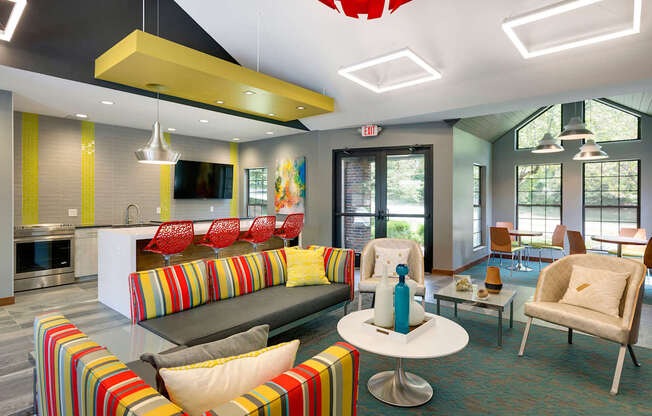 Community Room with seating, a full kitchen, and lounge chairs at Eden Commons in Eden Prairie, MN 55344
