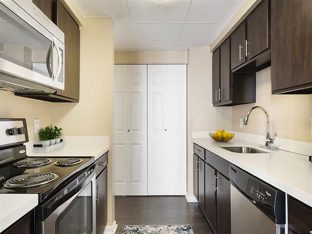 Modern kitchen w/ electric stove, dish washer, and granite counter tops at Prospect Place, NJ 07601