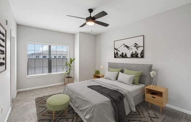 A bedroom with a bed, a chair, and a ceiling fan.