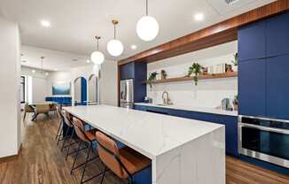 a large kitchen with blue cabinets and a white counter top
