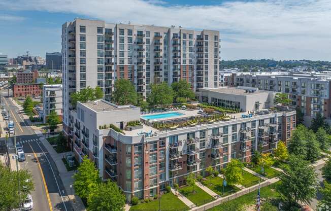 an aerial view of a building with a pool in the middle