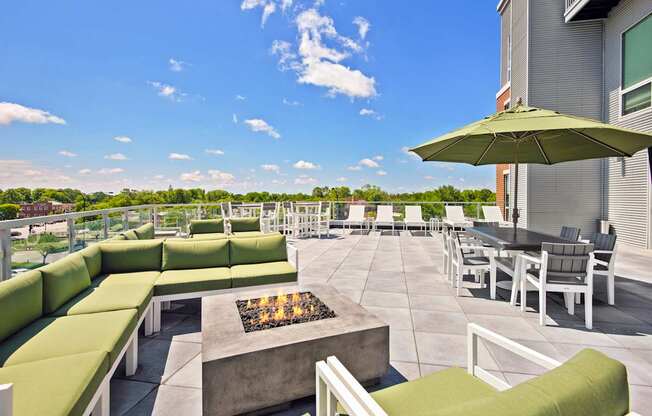 A patio with a fire pit and seating area.