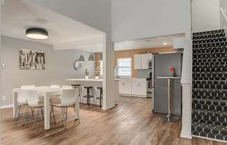 A dining area with a white table and chairs is shown.