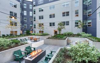 Relax in the meticulously landscaped courtyards offering lounge seating and a cozy fire table.