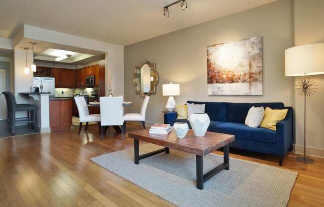 a living room with a blue couch and a coffee table