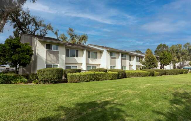 the apartments are located in a complex with a green lawn