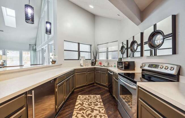 A modern kitchen with dark wood cabinets and stainless steel appliances.