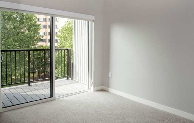 an empty bedroom with a balcony