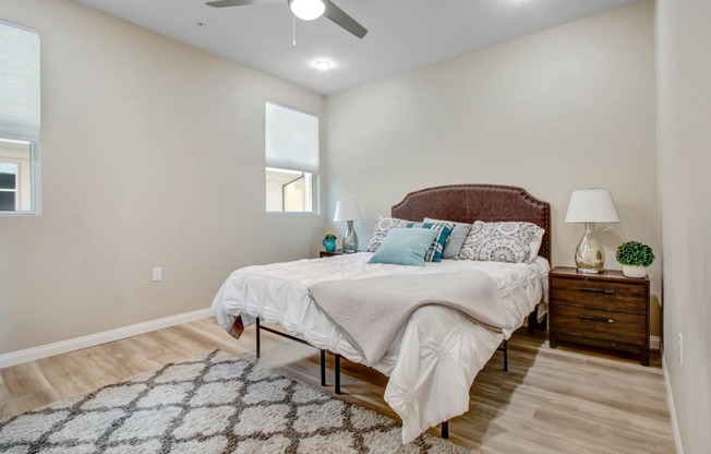 a bedroom with a bed and a ceiling fan