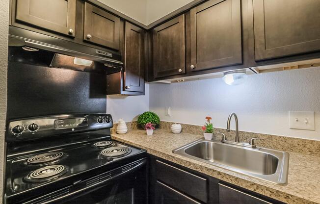 a stove top oven sitting inside of a kitchen with stainless steel appliances