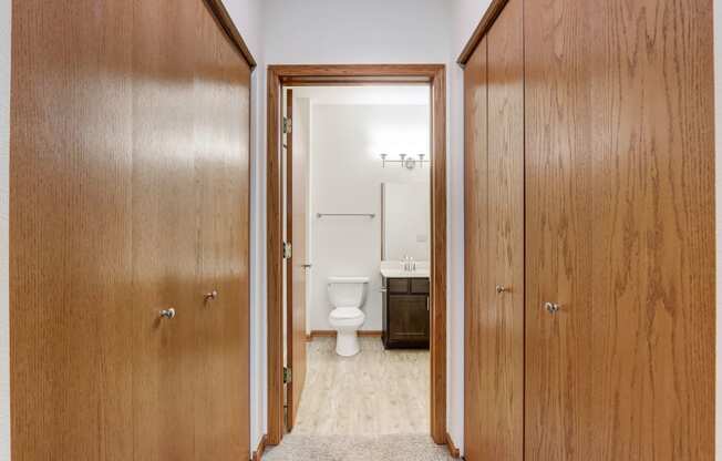 a bathroom with a toilet and wooden doors