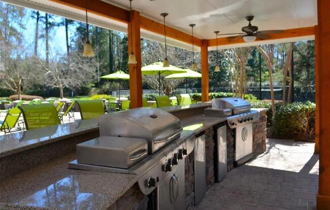 the outdoor kitchen is open to the patio