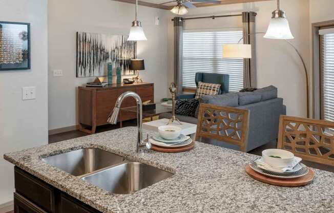 A kitchen with a granite countertop and a sink.
