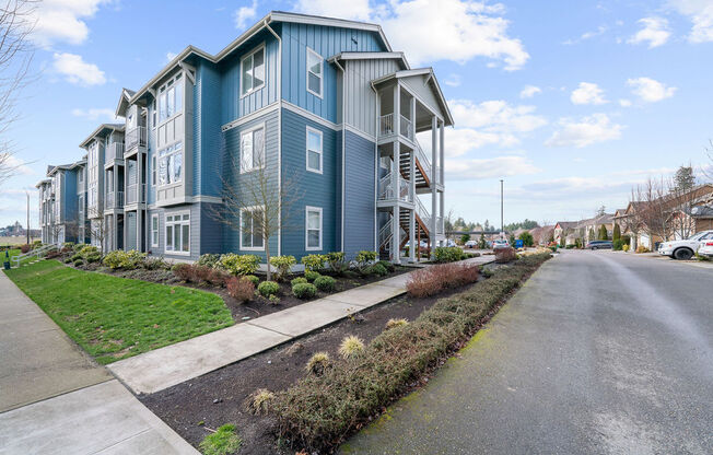 a blue building with stairs on the side of the road