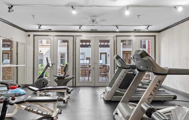 A gym with treadmills and exercise equipment.