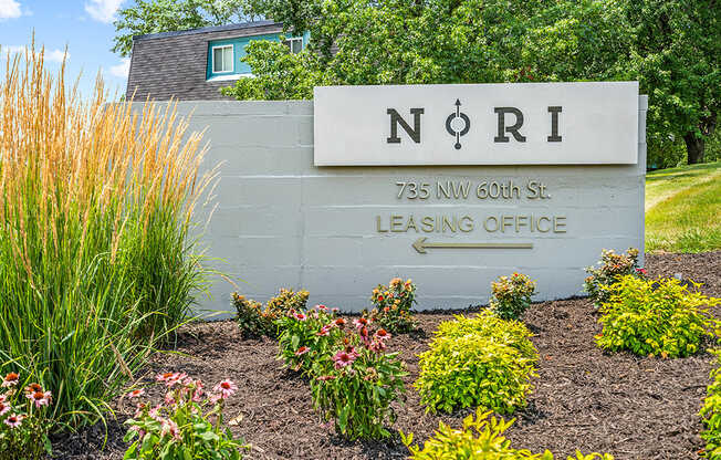 a sign for north 75 nu south st with flowers in front of it