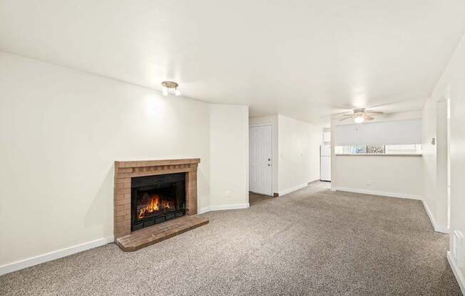 A room with a fireplace and carpeted floor.