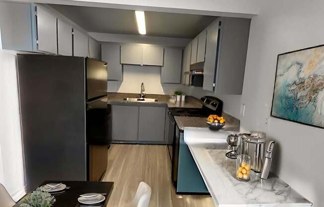 A modern kitchen with a black countertop and white chairs.