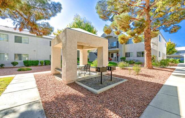 Gazeebo in the courtyard at Lush landscaping path at Country Club at The Meadows Senior Apartments in Las Vegas, NV, For Rent. Now leasing 1 and 2 bedroom apartments.
